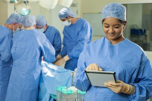Doctor Nurse Using Tablet Computer & Surgical Team